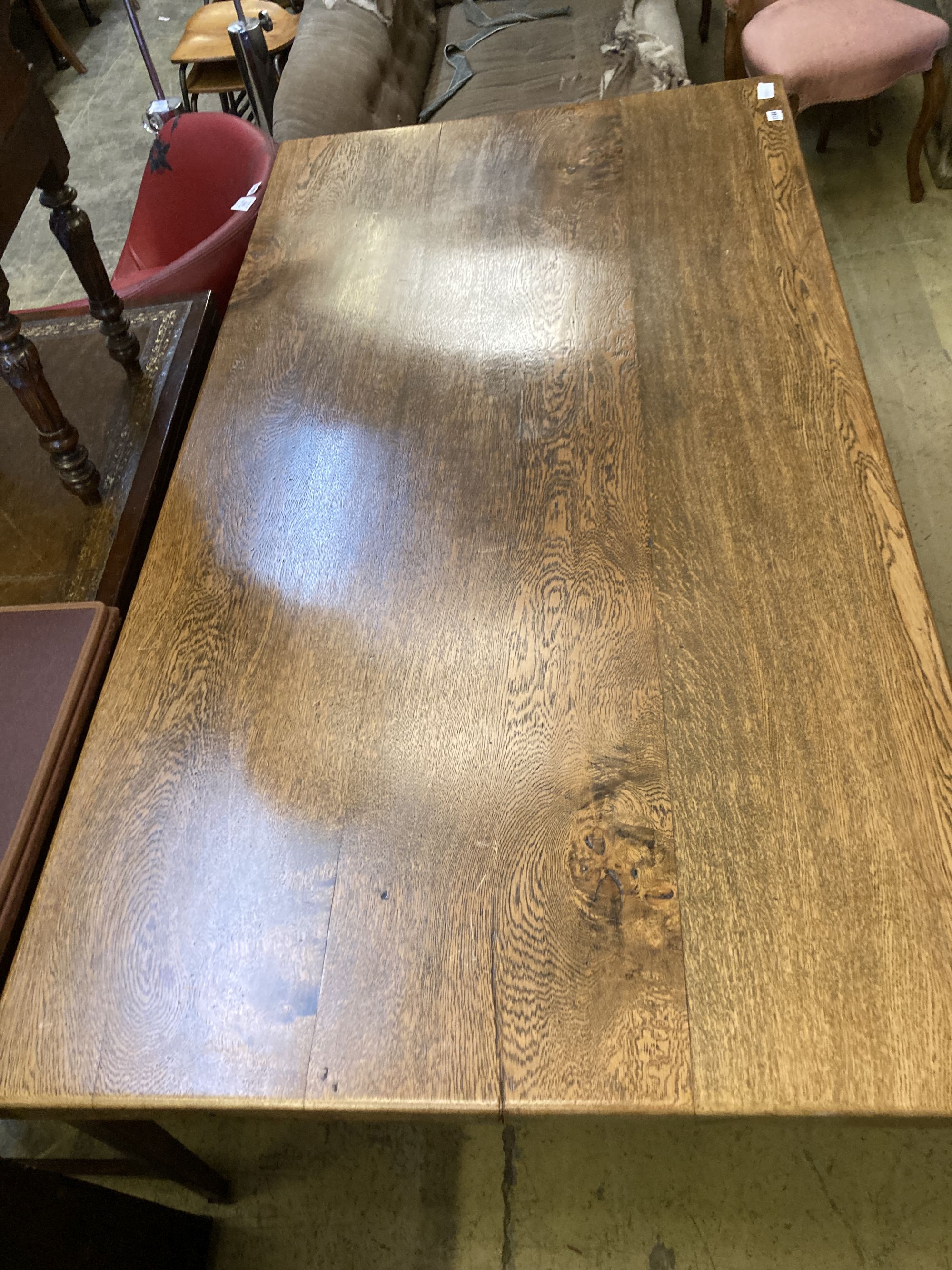 An 18th century style rectangular oak refectory dining table with vase shaped trestle ends, length 168cm, depth 90cm, height 76cm